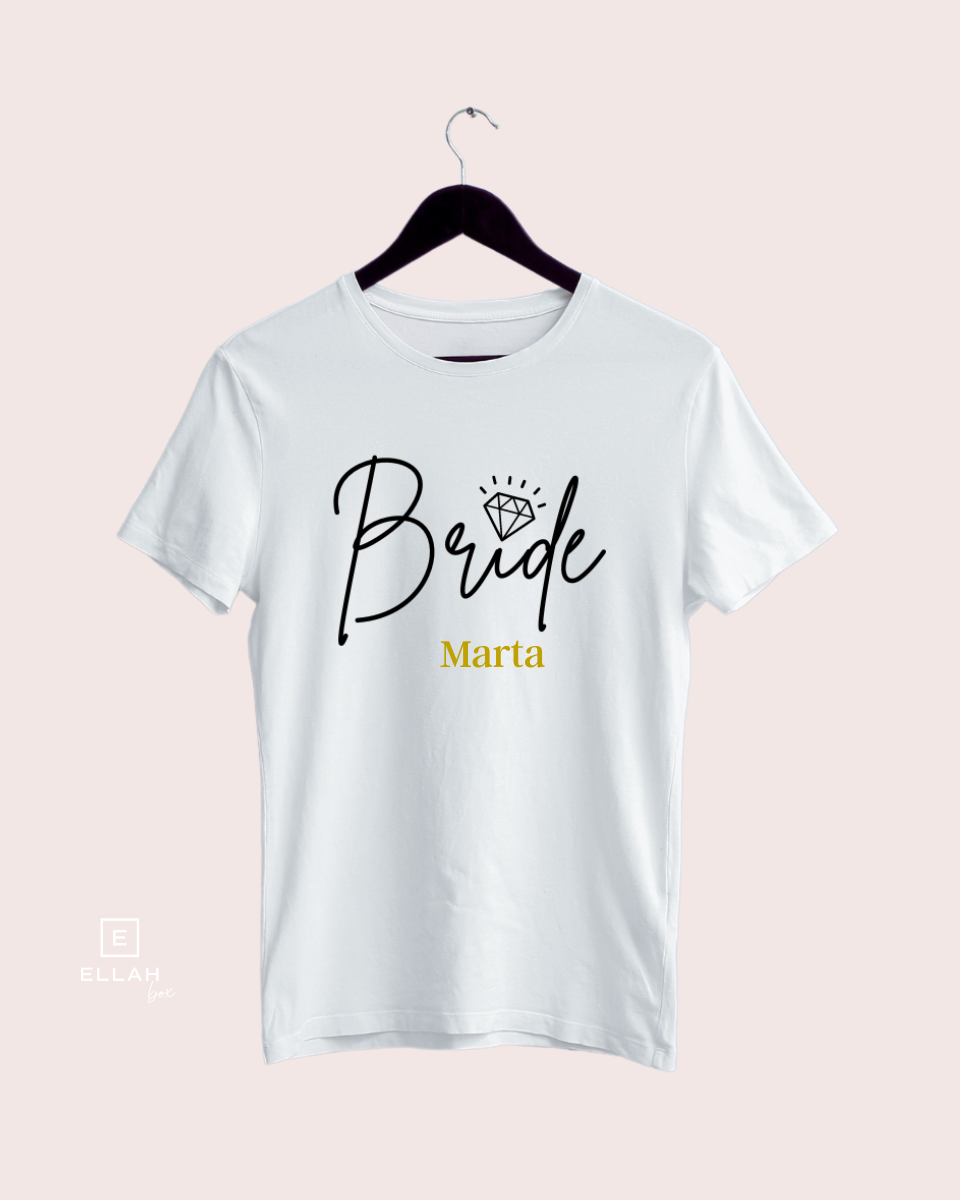 Camiseta Blanca | Bride personalizada-Ellahbox-▷【Camisetas para Despedida de Soltera】➡️ Novia-▷✅ ¿Qué es una despedida sin la novia y un cartel enorme donde ponga que sois las amigas de la novia? ⭐ Estas camisetas de despedida de soltera de Bride en blanco y dorado son cómodas y de buena calidad, no os fallarán en todo el día... ¡mega fiestón de Bride Squad asegurado!✅ ¡Entra en la tienda y hazte con ellas!